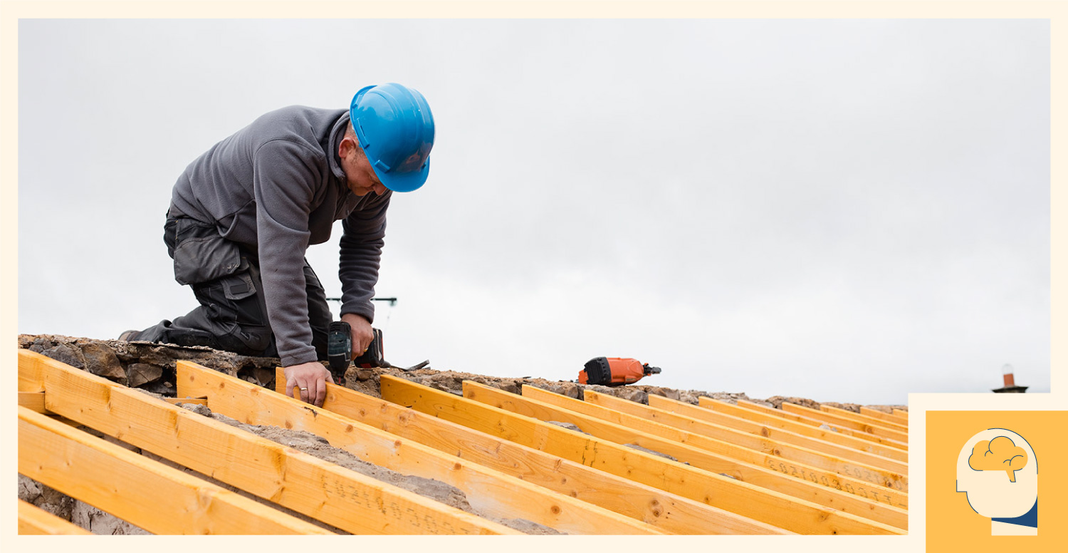 A construction draws on his knowledge of roofing and installs wood components.