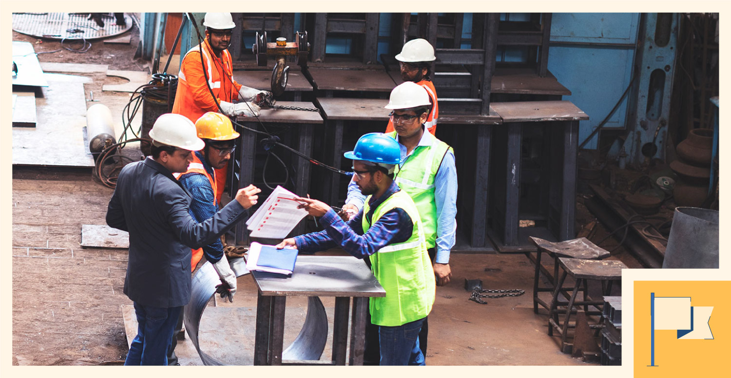 A construction manager leads a discussion with the contractors and employees.