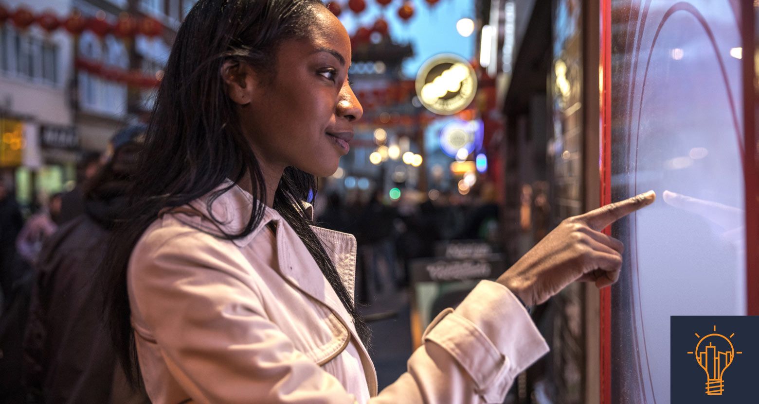 Woman using a smart screen in a commercial city center